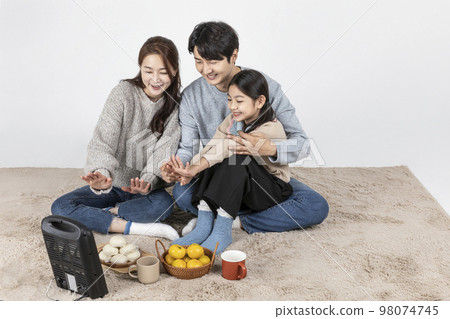 happy Asian Korean family, isolated in white background_warm oneself at a stove 98074745