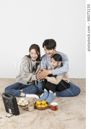 happy Asian Korean family, isolated in white background_warm oneself at a stove 98075230