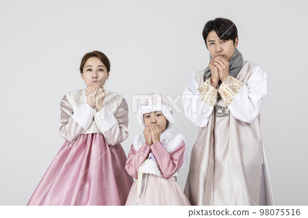 Korean family in Hanbok, isolated white background_blow breathing with cold Korean family in Hanbok, isolated white background_blow breathing with cold 98075516