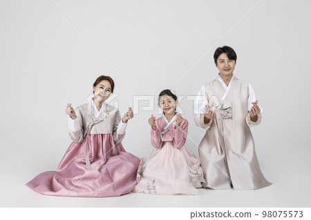 Korean family in Hanbok, isolated white background_sitting side by side with hand motion 98075573