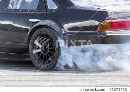Race drift car burning tires on speed track Race drift car burning tires on speed track 98075780
