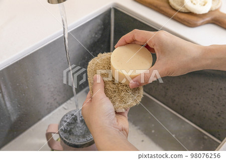 eco friendly habits hand gesture_using eco friendly sponge and dishwashing soap 98076256