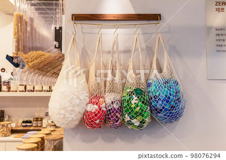 eco friendly habits hand gesture_a bag with a lid on it eco friendly habits hand gesture_a bag with a lid on it 98076294
