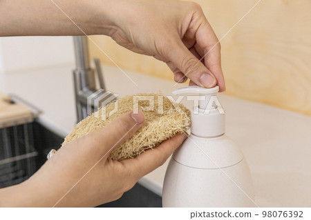 eco friendly habits hand gesture_using eco friendly sponge and detergent 98076392