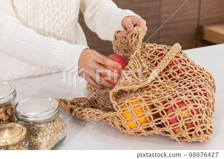 eco friendly habits hand gesture_taking fruit out of the shopping cart eco friendly habits hand gesture_taking fruit out of the shopping cart 98076427