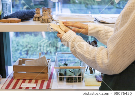 eco friendly habits hand gesture_visiting zero waste shop 98076430