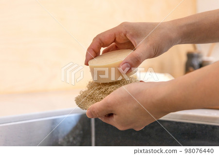 eco friendly habits hand gesture_using eco friendly sponge and dishwashing soap 98076440