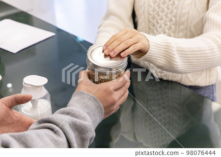 eco friendly habits hand gesture_a hand for a bottle of ingredients 98076444