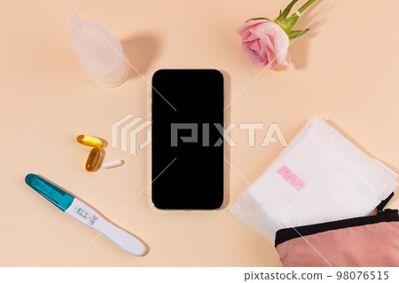 woman menstrual products_smartphone and sanitary pad woman menstrual products_smartphone and sanitary pad 98076515