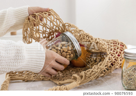 eco friendly habits hand gesture_taking out the ingredients from the shopping cart 98076593