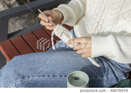 eco friendly habits hand gesture_taking out a stainless steel straw eco friendly habits hand gesture_taking out a stainless steel straw 98076659