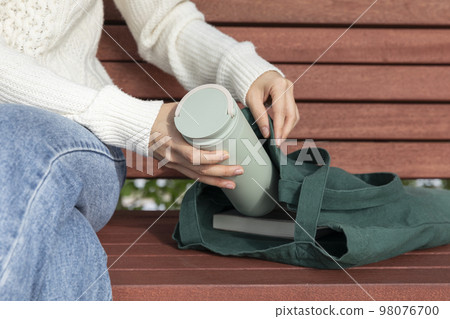eco friendly habits hand gesture_put the tumbler in the eco bag eco friendly habits hand gesture_put the tumbler in the eco bag 98076700