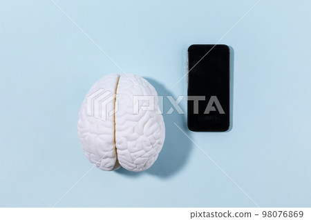 brain health and dementia series_a brain miniature and cell phone brain health and dementia series_a brain miniature and cell phone 98076869