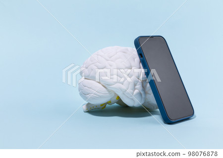 brain health and dementia series_a brain miniature and cell phone brain health and dementia series_a brain miniature and cell phone 98076878