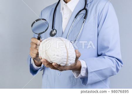 brain health and dementia series_examine the brain with a magnifying glass 98076895