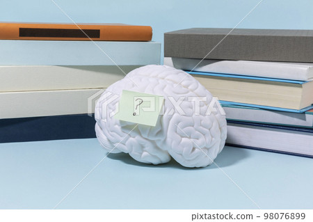 brain health and dementia series_stacked books and brain miniature brain health and dementia series_stacked books and brain miniature 98076899