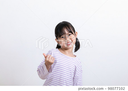 Asian Korean child with thumbs up hand motion Asian Korean child with thumbs up hand motion 98077102
