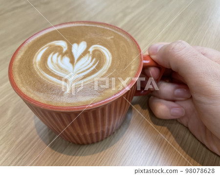 hand with cappuccino and cup 98078628