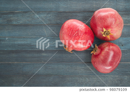 Pomegranate fruits on blue wooden vintage background 98079109