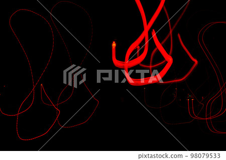 Long exposure, light painting photography, multi color swirl effect against black background. Night city lights  98079533