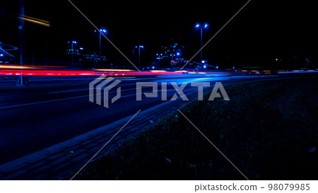 Lights of cars at night. Street line lights. Night highway city. Long exposure photograph night road. Colored bands of red light trails on the road. Background wallpaper defocused  98079985