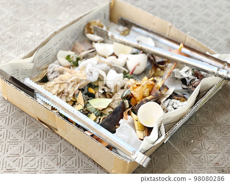 A lot of garbage in a cardboard box A lot of garbage in a cardboard box 98080286