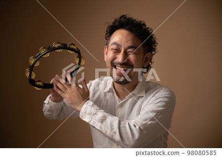 Image of a mysterious tambourine player Image of a mysterious tambourine player 98080585