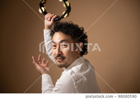 Image of a mysterious tambourine player Image of a mysterious tambourine player 98080590