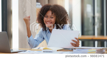 Black businesswoman work on laptop feel euphoric winning. Excited female triumph get good news from work Black businesswoman work on laptop feel euphoric winning. Excited female triumph get good news from work 98081471
