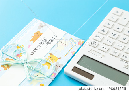 Gift envelope and calculator light blue background 98081556