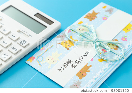Gift envelope and calculator light blue background 98081560