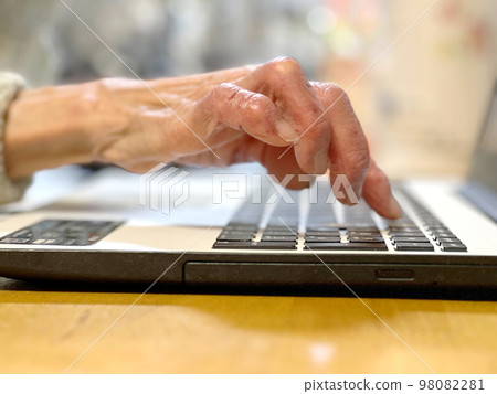 Elderly woman's finger touching the laptop keyboard _ from the side Elderly woman's finger touching the laptop keyboard _ from the side 98082281