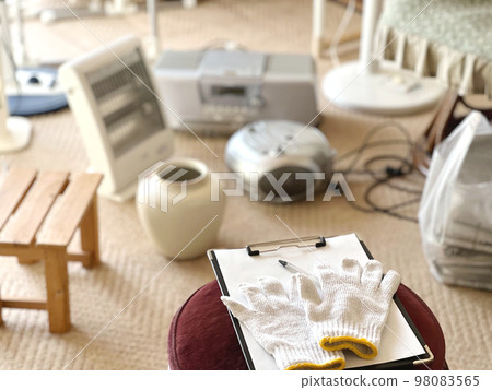 A clipboard and work gloves placed in front of many electrical appliances A clipboard and work gloves placed in front of many electrical appliances 98083565