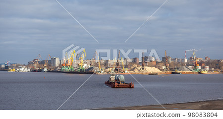 River port. Port cranes on the bank of the river. 98083804