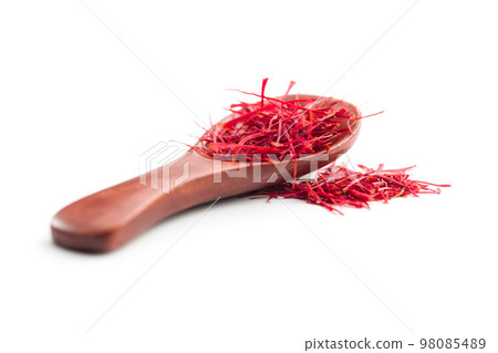Dried saffron spice in spoon isolated on white background. 98085489