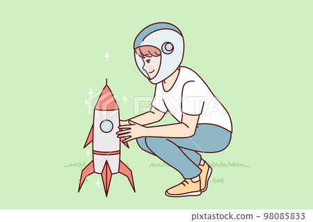 Little boy near toy rocket plays as astronaut, wanting to work in space industry. Vector image 98085833
