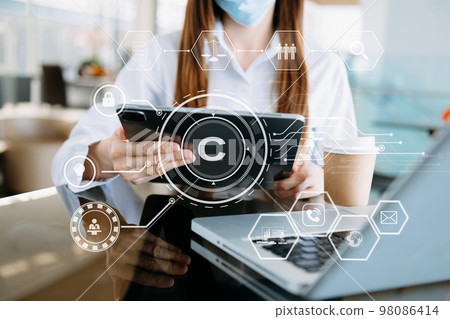 Copyright or patent concept, Person hand using laptop computer, tablet and smartphone with virtual screen copyright icon trademark, Creation ownership against piracy. 98086414