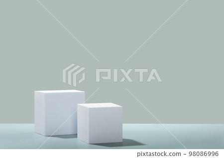 Abstract empty white podiums cubes with eucalyptus leaves on blue background 98086996