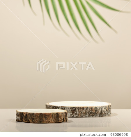 Wood slice podiums on beige background for cosmetic product mockup 98086998