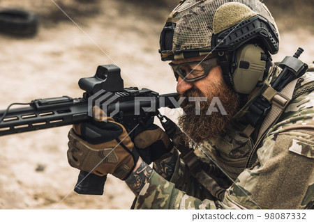 Sniper with rifle on a position 98087332