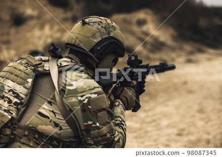 Sniper with rifle on a position 98087345