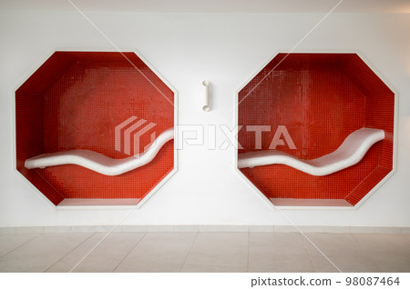 Close up of red benches in the wall 98087464