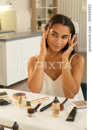 young woman sitting in front of mirror at home 98088465