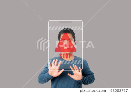 Young man showing stop gesture with stop sign virtual screen. 98088757
