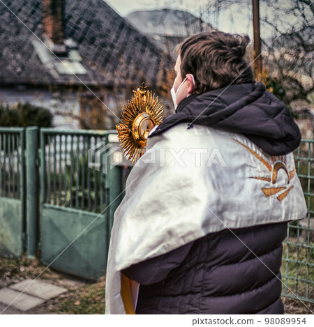 Priest with mask with eucharistic adoration on Easter sunday in village Martincek, Slovakia Priest with mask with eucharistic adoration on Easter sunday in village Martincek, Slovakia 98089954