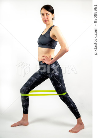 Athletic woman during fitness workout with rubber resistance band Athletic woman during fitness workout with rubber resistance band 98089961