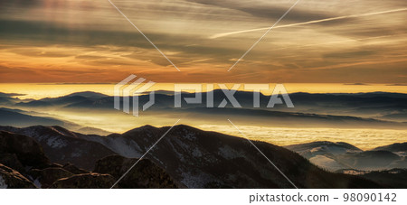 Mountain panorama - inversion in valley and colorful sky 98090142