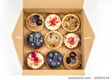 Tartlets in a box on white background Tartlets in a box on white background 98090144