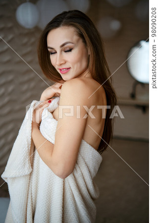 Soft focus portrait of cute woman with closed eyes with towel Soft focus portrait of cute woman with closed eyes with towel 98090208