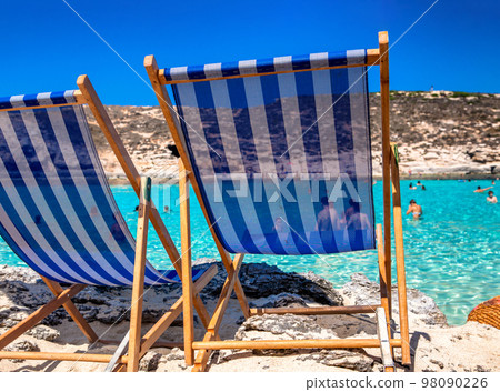 Two empty deck chairs and sea at backgroung Two empty deck chairs and sea at backgroung 98090226